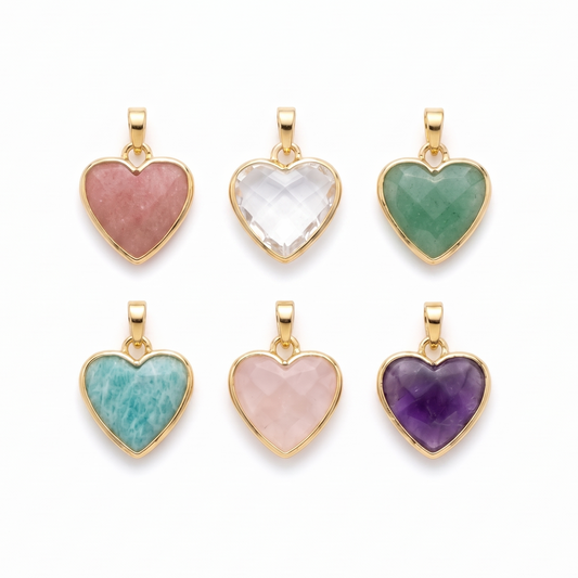 Set of six heart-shaped gemstone pendants with gold frames on a white background